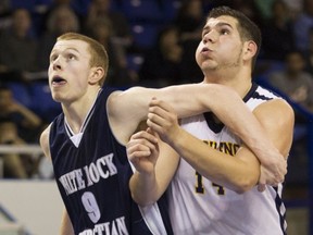 Kitsilano Blue Demons' big man Luka Zaharijevic (right), battling WRCA's Peter Spangehl, is headed for a university career next season at UBC. (PNG photo)