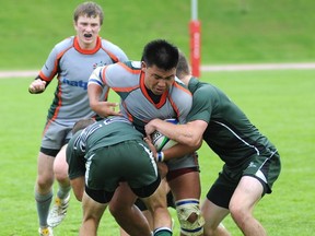 Earl Marriott Mariners (grey) battled the Robert Bateman Timberwolves on Wednesday in the quarterfinal round of the BC boys AAA rugby championships in Abbotsford. (John Van Putten, The Abbotsford Times)