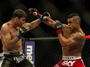 Last time out, Vitor Belfort (left) stopped Michael Bisping in the second round. Can he do the same against Luke Rockhold this weekend? (Photo credit should read YASUYOSHI CHIBA/AFP/Getty Images)
