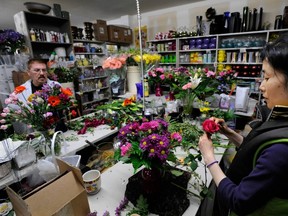 Designers Kuri Yamaura (right) and Denis Doucette (left) create a couple of the several hundred bouquets for the Mother's Day orders at Nature's Wonders Florist on East Second Avenue in Vancouver for Mother's Day in 2008. (Ric Ernst/PNG FILES)