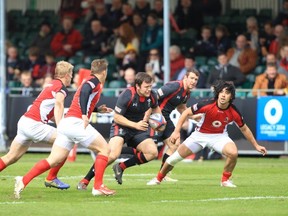 John Moonlight, Jeff Hassler and Nathan Hirayama of Canada work on defence against Wales' Adam Thomas on day two of the IRB Sevens in Glasgow (Maritn Seras Lima/IRB)