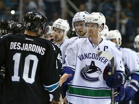 Canucks captain Henrik Sedin congratulates the San Jose Sharks' Andrew Desjardins after the Sharks swept the Canucks in their opening round NHL playoff series on May 7, 2013. Getty Images photo.