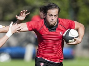 St. George's Saints' No. 8 Mitchell Rothman uses a straight-arm to fend off a would-be Prince of Wales tackler during opening round of the Lower Mailand senior boys rugby championships Tuesday in Vancouver. (Gerry Kahrmann, PNG)