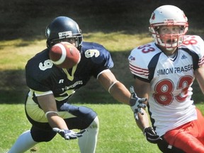 SFU receiver Victor Marshall eyes a potential reception in his first-ever game with the Clan, a clash against crosstown rival UBC and his soon-to-be teammate in defensive back Sam Carino. (PNG Photo)