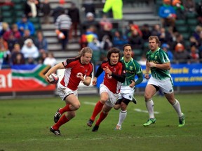 Conor Trainor and Taylor Paris sprint away from South Africa's Paul Delport and Frankie Horne in IRB Sevens action in Glasgow (Martin Seras Lima/IRB)