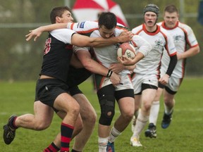 Yale's Ryan Rizzo (left) lays a tackle on Earl Marriott's hard-charging Colin Stonier during top 10 contest earlier this season. Both Surrey's Mariners and the Lions of host Abbotsford hit the quarterfinal stage of provincial AAA action Wednesday. (PNG photo)