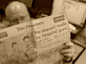 Province columnist Gordon Clark reads a copy of the May 31, 1957, Province sent in by Golden resident Rafaqat Chaudhary. (Les Bazso/PNG PHOTO ILLUSTRATION)