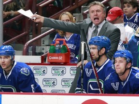 Associate coach Rick Bowness of the Vancouver Canucks yells from the bench during their NHL game against the Chicago Blackhawks at Rogers Arena on Feb. 1, 2013.  (Photo by Jeff Vinnick/NHLI via Getty Images)