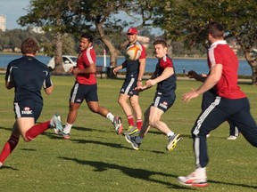 British and Irish Lions' Brian O'Driscoll, second from right, passes a ball during a training session in Perth, Australia, Monday, June 3, 2013. (AP Photo/Bohdan Warchomij) ORG XMIT: PER112