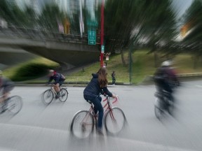 Cyclists ride through the intersection of Main and Union Streets. Vancouver council has delayed a controversial bike lane there.(PNG PHOTO ILLUSTRATION)