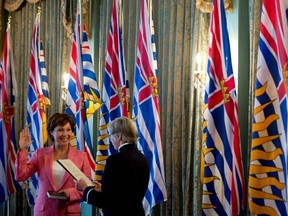 Many readers are shocked that Christy Clark, here being sworn in as premier by Lt.-Gov. Judith Guichon, would give huge raises to party staff. (THE CANADIAN PRESS FILES)