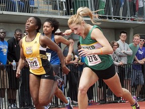 Langley Secondary's Georgia Ellenwood (right) uses body language to claim 100 metres Saturday over a field that inlcuded Kelowna's Elisa Joyce. (Les Bazso photo)