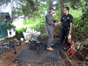 Elderic Furlotte (left) shakes James Cunningham’s hand for saving the life of his friend Richard, a homeless man whose mattress caught fire in a camp behind an Abbotsford Canadian Tire store. (ABBOTSFORD TIMES FILES)