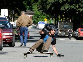 Graham Collingwood, who is sponsored by and works for Landyachtz longboards, demonstrates the hands down slide using slide glove on this street in Vancouver on June 10, 2013. (Stuart Davis/PNG FILES)