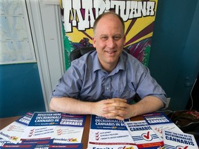 Dana Larsen at Sensible B.C.’s Vancouver headquarters displays posters Monday promoting the legalization of marijuana. (Steve Bosch/PNG FILES)