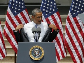 U.S. President Barack Obama removes his jacket before speaking about climate change on Tuesday. Obama proposes sweeping steps to limit heat-trapping pollution from coal-fired power plants and to boost renewable energy production on federal property, resorting to his executive powers to tackle climate change and sidestepping the partisan gridlock in Congress. (THE ASSOCIATED PRESS)