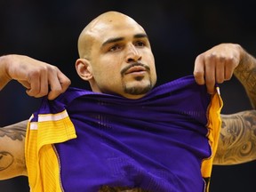 Coming off a rookie season with the Los Angeles Lakers, Handsworth Secondary's Robert Sacre, a 2007 Head of the Class honouree, shows off his Vancouver skyline tattoo to the world. (Getty Images)