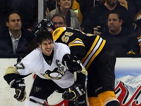 Sidney Crosby of the Pittsburgh Penguins gets out from the clutches of the Boston Bruins' Johnny Boychuk June 5, 2013 in Boston. Getty Images file photo.