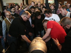 Craft beer lovers crowd around the ceremonial cask for a sample of Altbiere at the VCBW 2013 Opening Night Gala.