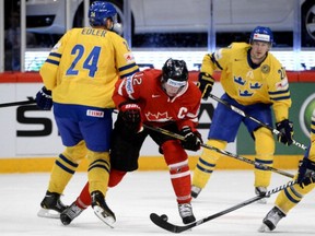 Sweden's Alexander Edler (24) hits Canada's Eric Staal during the quarterfinal match at the 2013 IIHF Ice Hockey World Championships on May 16  in Stockholm. (Photo: JONATHAN NACKSTRAND/AFP/Getty Images)
