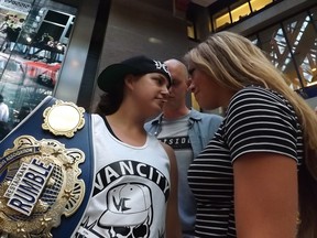 Defending AFG champion "Sugar" Shay Washburn gets a final look at her opponent Andrea Chromik at the press conference Tuesday night. Photos: Lev Jackson