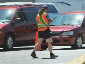 Ferry worker at Horseshoe Bay in West Vancouver on July 11 helps load vehicles. (Wayne Leidenfrost/ PNG FILES)