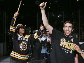 Boston bombing survivor Jeff Bauman and his rescuer, Carlos Arredondo at a Stanley Cup final game in Boston on June 24, 2013. AP file photo.