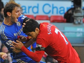 Liverpool's Luis Suarez and Chelsea's Branislav Ivanovic in action in April 2013. Getty Images file photo.