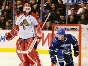 The Canucks' Mason Raymond and the Panthers' Tomas Vokoun. Getty Images file photo.