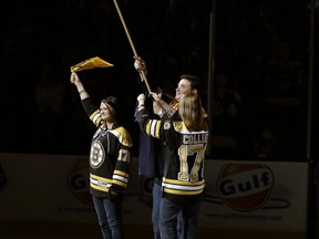 The family of slain MIT police officer Sean Collier raises the Boston Strong flag before game 3 of the Stanley Cup final in Boston. Getty Images photo.