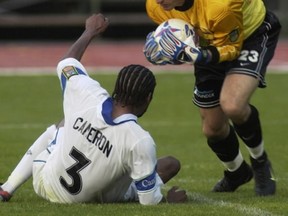 Seattle Sounders goalkeeper Preston Burpo in action against the Vancouver Whitecaps' Kevan Cameron in 2002. The Province file photo.