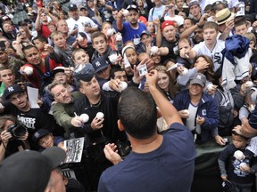 New York Yankees' Alex Rodriguez signs autographs in Chicago on Aug. 5, 2013. AP photo.