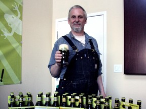 Dead Frog brewmaster Tony Dewald with the brewery's new six-pack lineup.