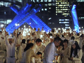Diners participating in the 2012 Diner en Blanc light sparklers at Jack Poole Plaza in Vancouver on Aug. 30, 2012. (Photo: Gerry Kahrmann / PNG)