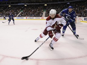 .The Vancouver Canucks' Alexander Edler watches the Phoenix Coyotes' Gilbert Brule in a February 2012 game.