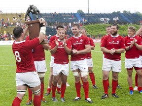 Canada's captain Aaron Carpenter raises the CANAM cup after Canada beat the US Eagles 28-25 in an international rugby Test match in Kingston, Ont., on Saturday, June 9, 2012. Canada takes the first steps to the 2015 Rugby World Cup on Saturday, a qualifying journey that can be short or long. THE CANADIAN PRESS/Lars Hagberg