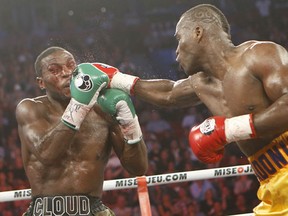 Adonis Stevenson pumps the jab into the face of a bloody Tavoris Cloud. Photos: Herby Whyne