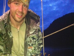 B.C.-raised Clayton Stoner, an NHL player for the Minnesota Wild, holds up a grizzly bear paw after a trophy hunt that has been widely criticized. (HANDOUT PHOTO)