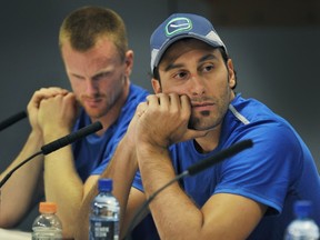 Canucks goalie Roberto Luongo, right, and forward Daniel Sedin, talk to reporters at a media conference in Vancouver on Sept. 11, 2013. (Wayne Leidenfrost/PNG FILES)