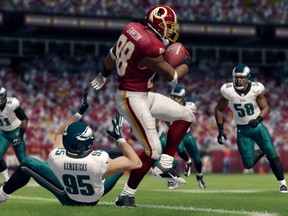 This video game image released by EA Sports shows an animated version of Redskins' Pierre Garcon, center, during game action in ìMadden NFL 25.î (AP Photo/EA Sports)