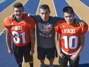 New Westminster Hyacks' running back coach Darnell Sikorski (centre) with pupils Julian Ramirez (left) and Angelo Tanjuaquio. (Arlen Redekop, PNG photo)