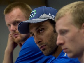 Daniel Sedin, Roberto Luongo and Jannik Hansen of the Vancouver Canucks. Canadian Press photo.