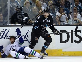The Vancouver Canucks' Ryan Kesler gets pasted to the boards by the San Jose Sharks' Patrick Marleau in the 2013 Stanley Cup playoffs.
