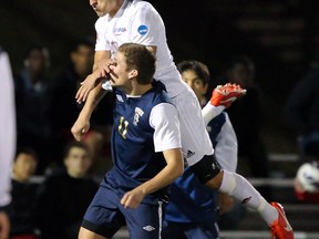 Simon Fraser University midfielder Alex Rowley battles in the air with South Dakota School of Mines' Andreas Skau on Thursday. (Ron Hole, SFU athletics)