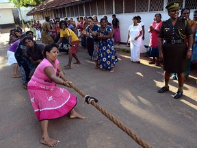 Sri Lankan prisoners have fun playing tug of war. Getty Images photo.