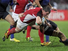 Canada's N°8 Aaron Carpenter is tackled by France's flanker Julien Bonnaire during the 2011 Rugby World Cup pool A match France vs Canada at McLean Park in Napier on September 18, 2011. (Marty Melville/AFP/Getty Images)