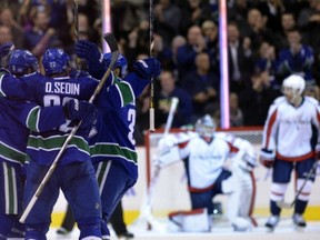 The way it's going, the Sedins look like they are going to be doing a lot of this.
 (Photo by Rich Lam/Getty Images)