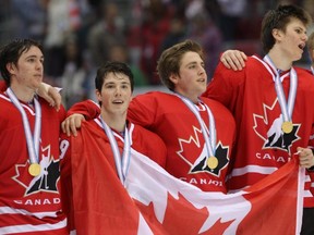 Young Canadian hockey players sing O Canada after beating the U.S. at the World Under-18 Hockey championships in Sochi, Russia, on April 28. (THE CANADIAN PRESS FILES)