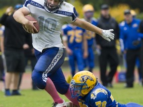 Jordan Worth of Victoria's Belmont Bulldogs tries to shimmy free from the tackle of Handsworth Royals' Matt Anderson during Triple A high school football action Friday in North Vancouver. Belmont returned to the capital city with a 24-23 win. (Gerry Kahrmann, PNG photo)