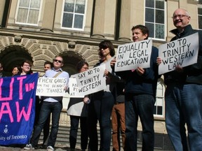 About 30 protesters opposed to Trinity Western University’s application to open a law school in Langley waved signs outside Osgoode Hall in Toronto on Oct. 18. Some readers say they are the ones demonstrating intolerance. (PNG FILES)